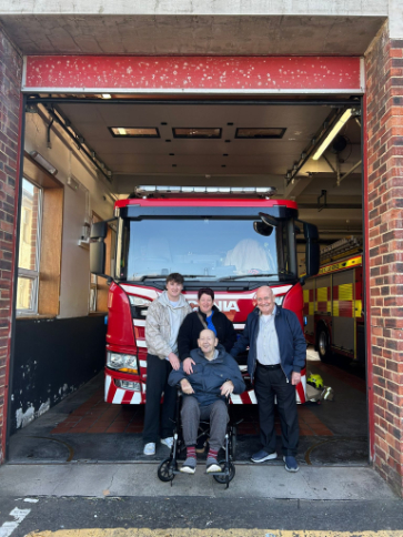 Resident at a fire station with family